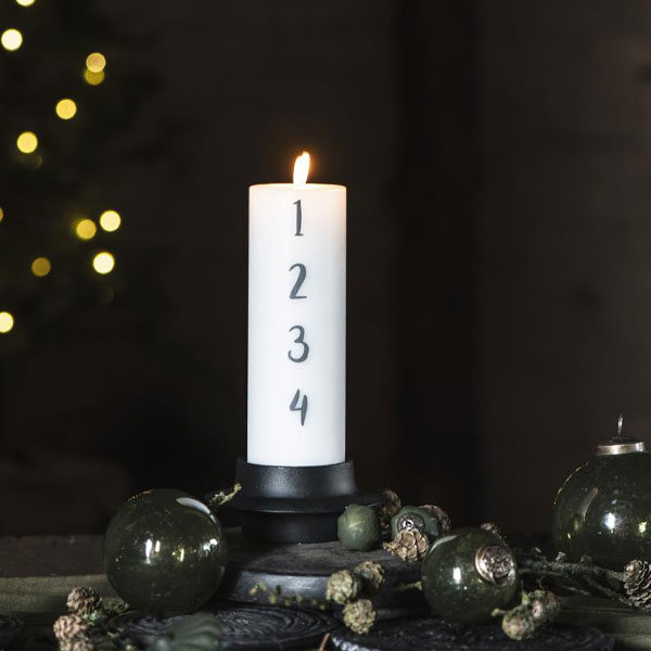 Adventsljus med gråa siffror, 1-4 för varje advent.